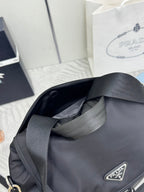 PRADA 25S EXPLORE BACKPACK 39 IN BLACK RE-NYLON AND CALFSKIN