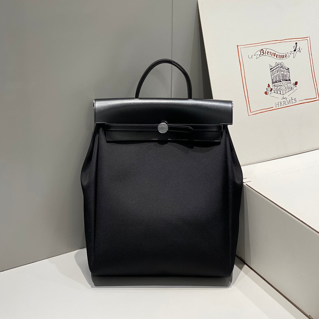 HERBAG A DOS ZIP RETOURNE BACKPACK 29 IN BLACK CANVAS AND CALFSKIN