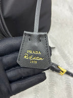 BUCKET BAG 19 IN BLACK RE-NYLON AND CALFSKIN HANDLE